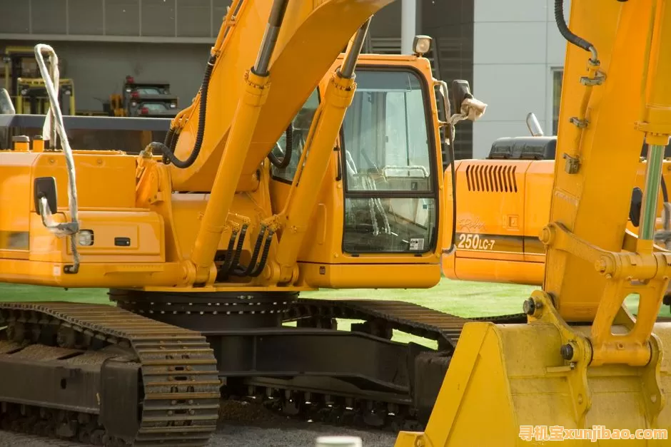 Close-up of yellow excavators at a construction site, showcasing industrial machinery and engineering.